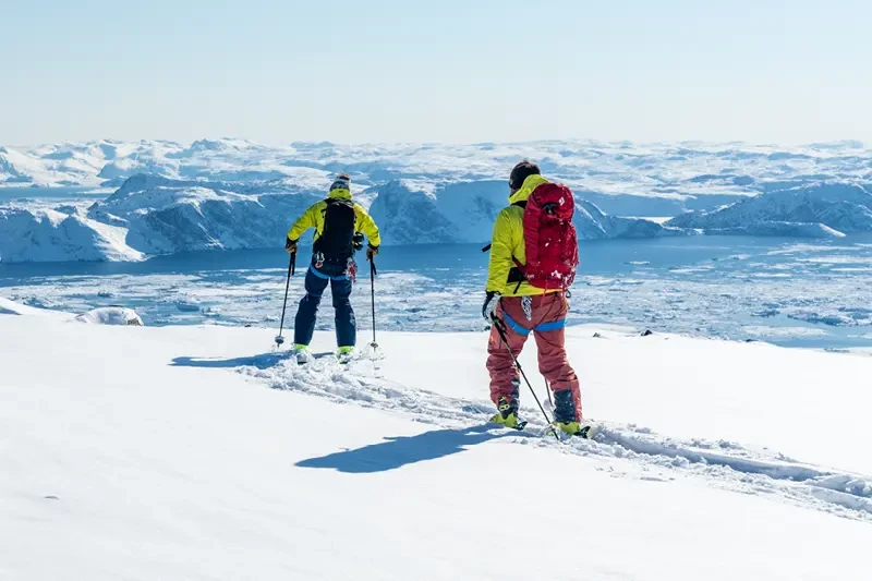 Two EYOS explorers walking through the snow