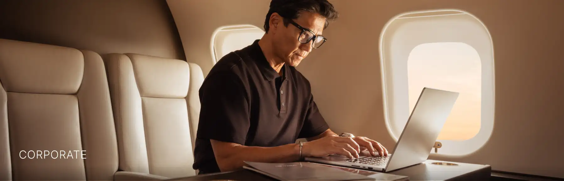 Corporate man using his laptop on a VistaJet
