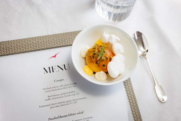 Bowl of Asian food sitting on a VistaJet menu
