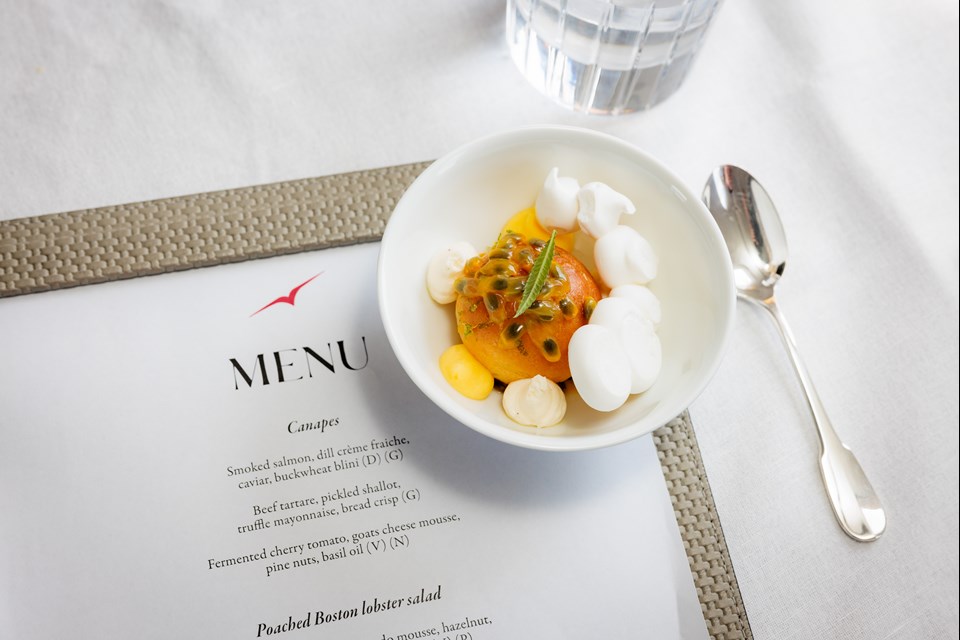 Bowl of Asian food sitting on a VistaJet menu