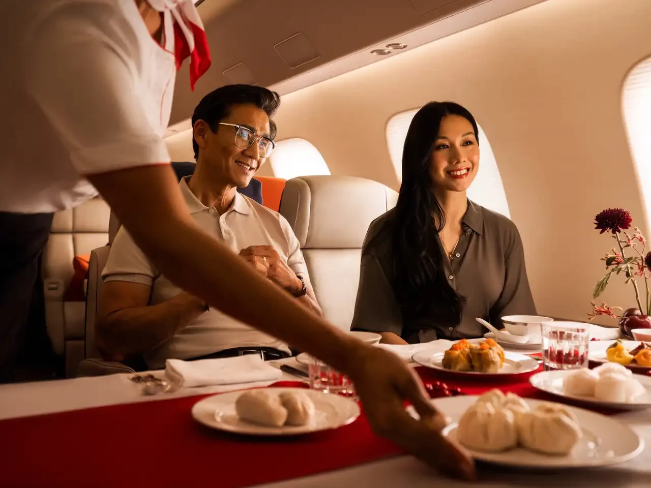 A couple enjoying tailored in-flight offerings.