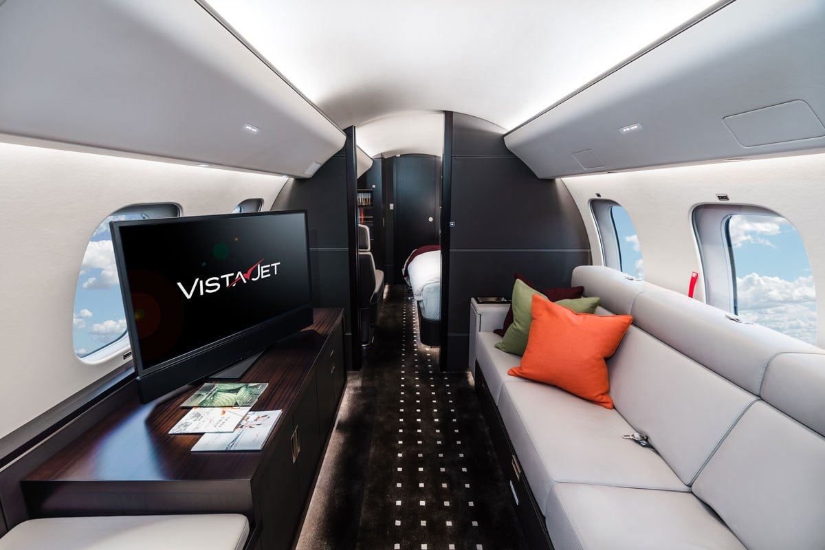 VistaJet airhostess serving guests signature seasonal dishes